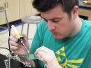 TI participant and physics teacher Josh Leckman solders components to a project board.
